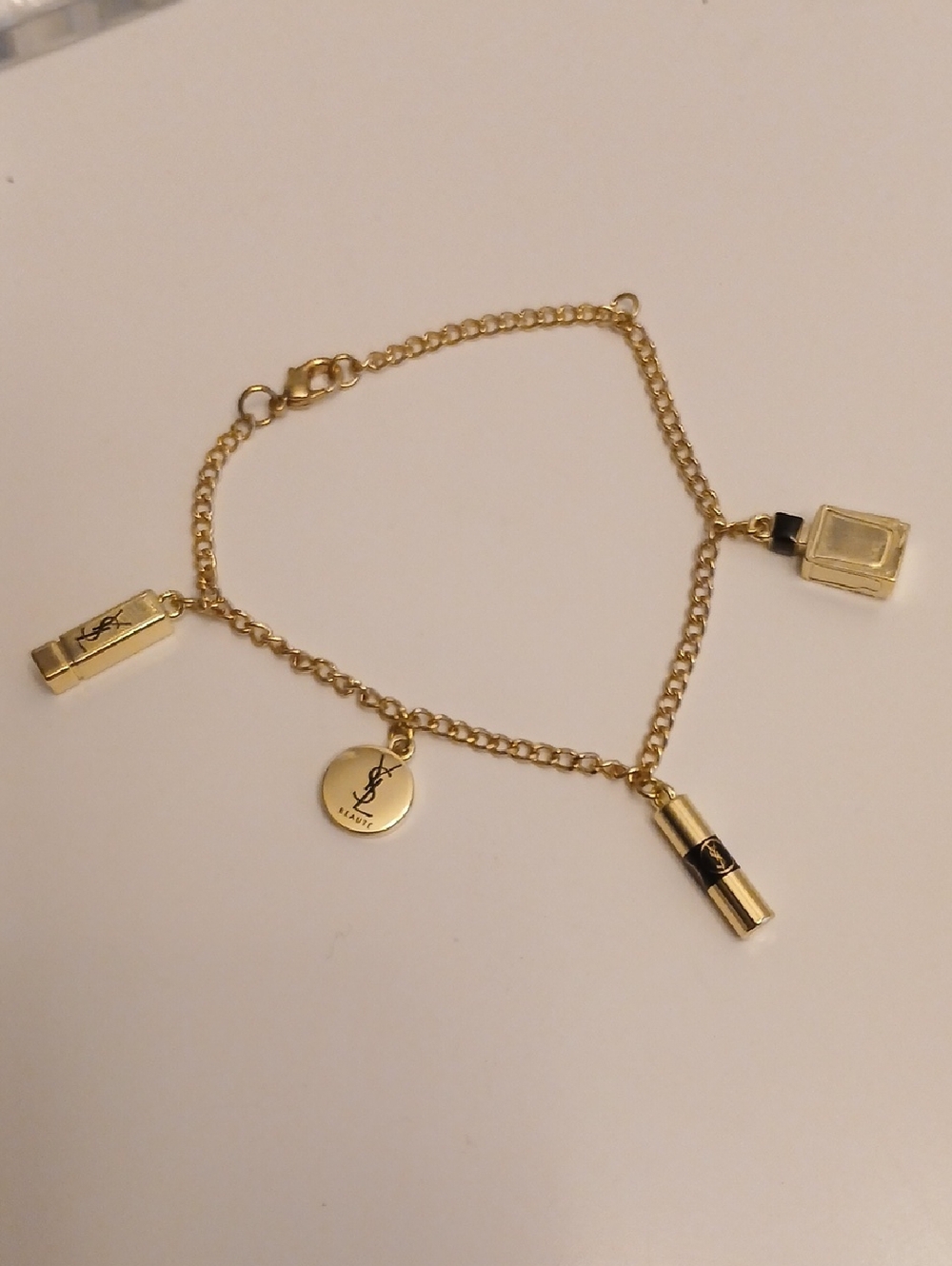 Yves Saint Laurent Gold Charm Bracelet with Logo Disc & Lipstick Charms